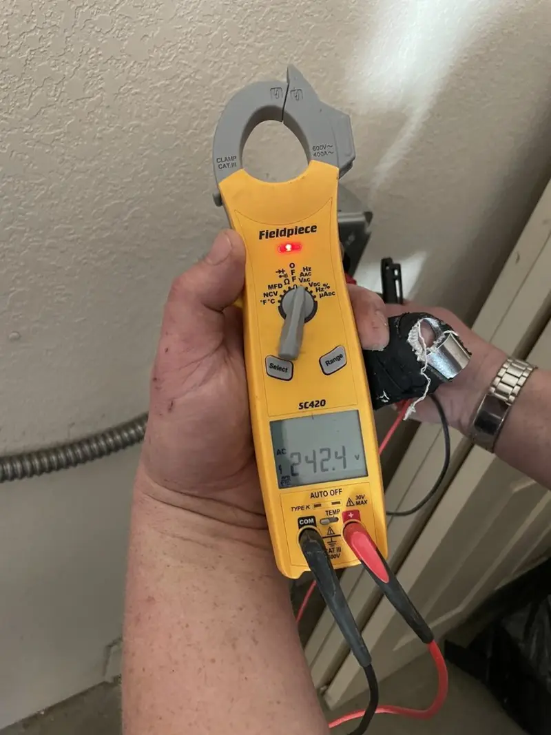 Voltage testing with clamp meter during Electrical Installation Services in Desloge
